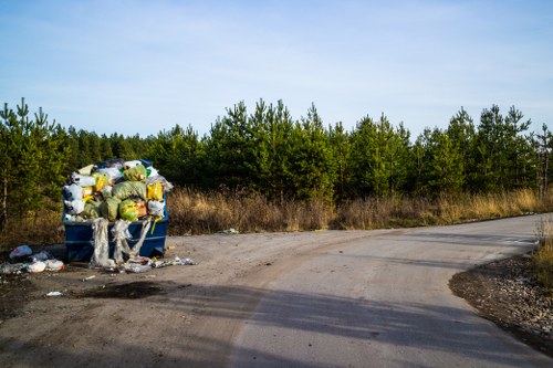 Construction site with an enclosed skip for debris disposal